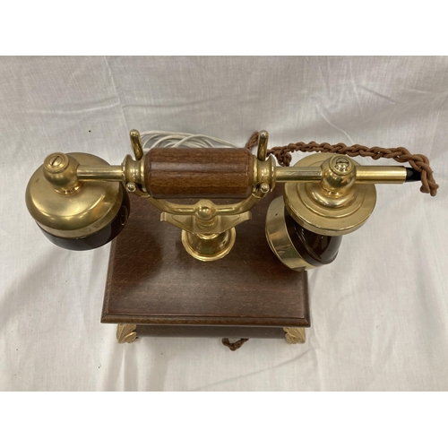 33 - A VINTAGE STYLE OAK TELEPHONE WITH BRASS DETAILING