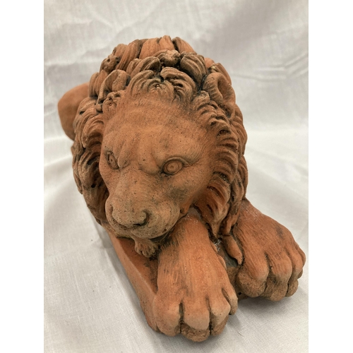 35 - A PAIR OF TERRACOTTA LION STATUES LENGTH 30CM