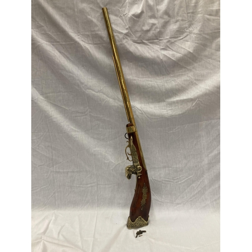 6 - A DECORATIVE ORNAMENTAL BRASS MUSKET