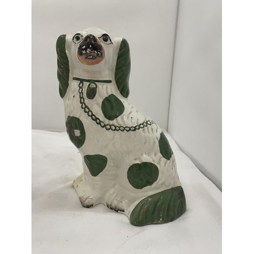 107 - A PAIR OF GREEN AND WHITE STAFFORDSHIRE DOGS HEIGHT 26CM