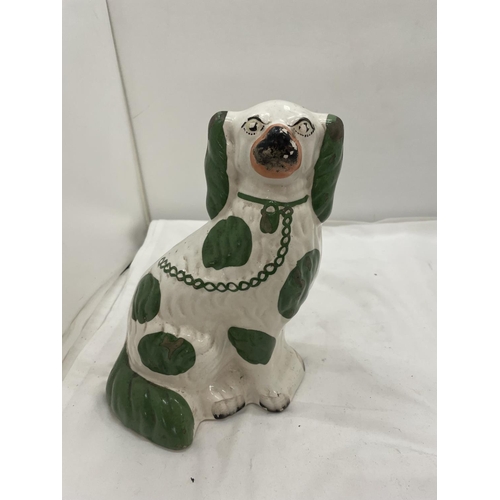 107 - A PAIR OF GREEN AND WHITE STAFFORDSHIRE DOGS HEIGHT 26CM