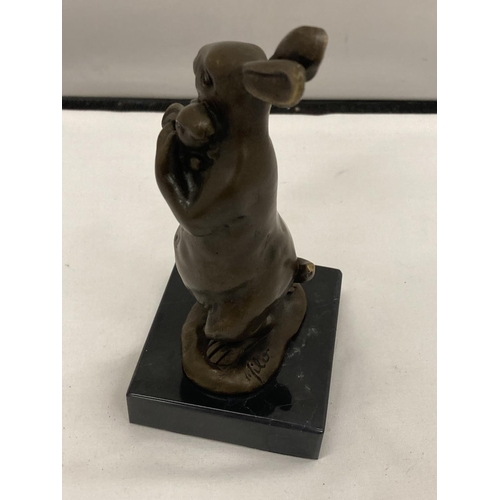 160A - A SIGNED BRONZE RABBIT HOLDING HER BABY ON A MARBLE BASE