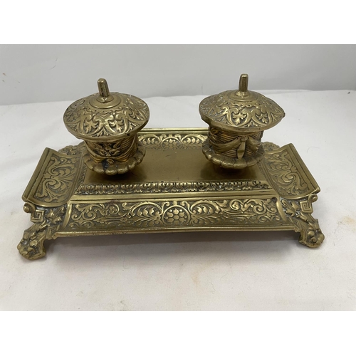 173 - AN ELABORATELY DECORATED BRASS INKWELL