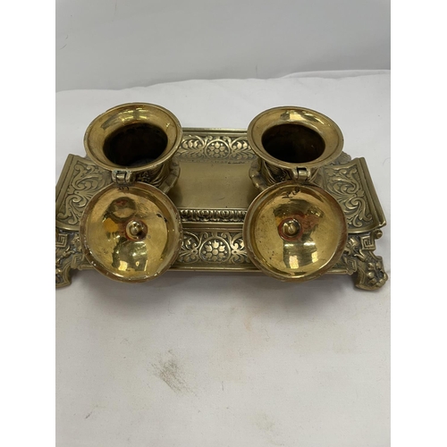 173 - AN ELABORATELY DECORATED BRASS INKWELL