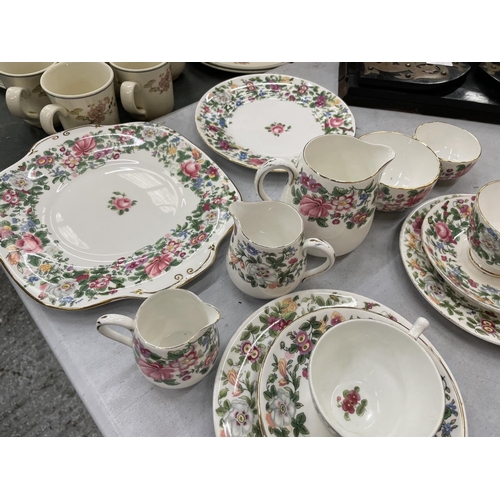 180 - A QUANTITY OF CROWN STAFFORDSHIRE FLORAL TEA WARE TO INCLUDE CUPS, SAUCERS, JUGS, PLATES AND SUGAR B... 