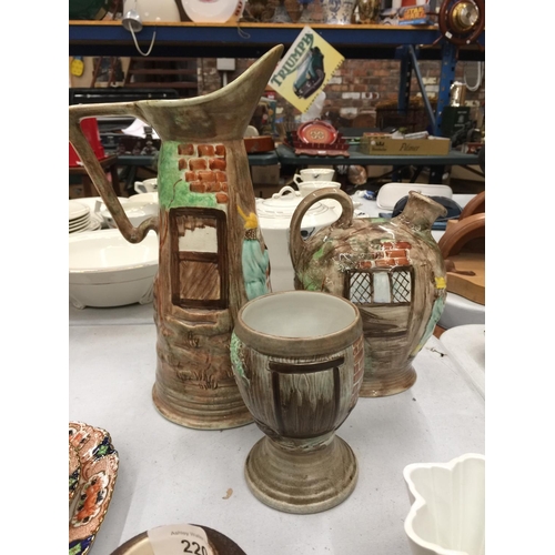 221 - A COLLECTION OF H J WOOD POTTERY TO INCLUDE TWO JUGS AND A GOBLET DECORATED WITH EMBOSSED SCENES