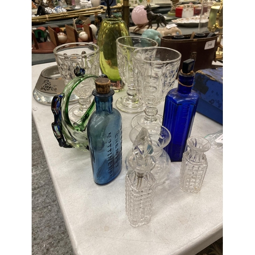 249 - A QUANTITY OF GLASSWARE TO INCLUDE DESSERT GLASSES VASES, VINTAGE BOTTLES, ETC