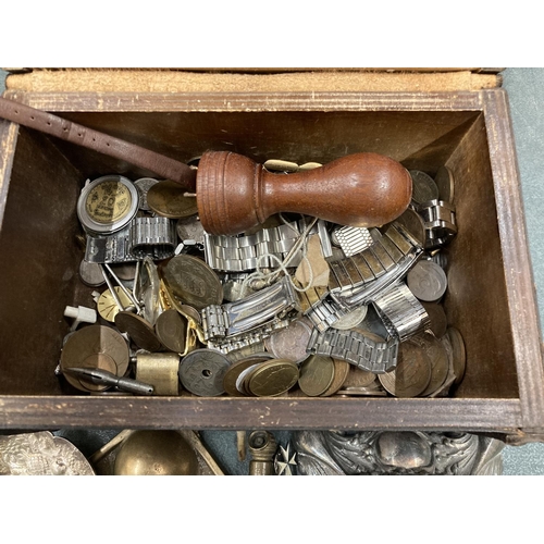 299 - A WOODEN DOMED BOX CONTAINING A QUANTITY OF COINS, WATCH PARTS, A SILVER PLATED CANDLESTICK, BUDDAHS... 