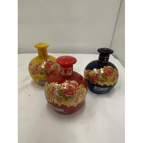 311 - SIX VARIOUS BOTTLES OF CHINESE SPIRIT THREE IN COLOURFUL CERAMIC BOTTLES WITH FLORAL DECORATION