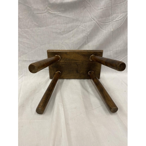 46 - A VINTAGE OAK RECTANGULAR FOUR LEGGED STOOL