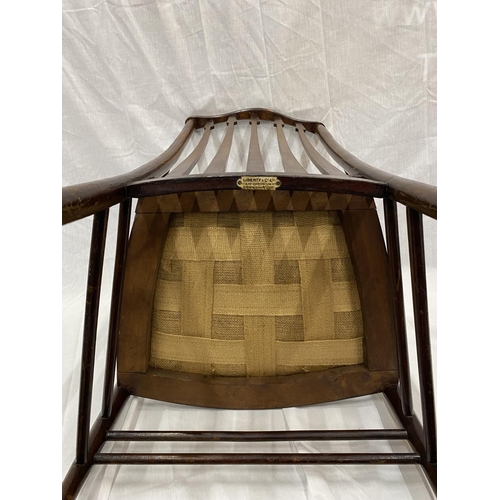 47 - AN EARLY 20TH CENTURY LIBERTY BIRMINGHAM BEECH NURSING CHAIR WITH TURNED LEGS AND STRETCHERS, ARROW ... 