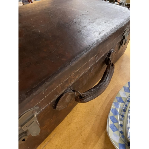 490 - A VINTAGE LEATHER SUITCASE IN NEED OF RESTORATION