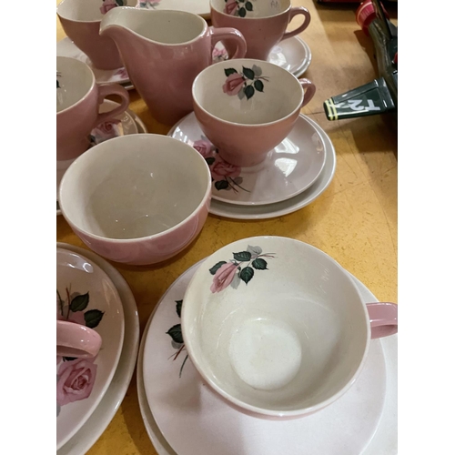 495 - A QUANTITY OF WADE PINK AND FLORAL TEAWARE TO INCLUDE TRIOS, CREAM JUG, SUGAR BOWL, AND SANDWICH PLA... 