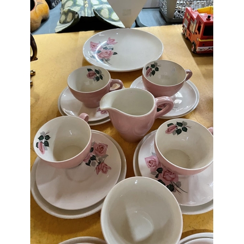 495 - A QUANTITY OF WADE PINK AND FLORAL TEAWARE TO INCLUDE TRIOS, CREAM JUG, SUGAR BOWL, AND SANDWICH PLA... 