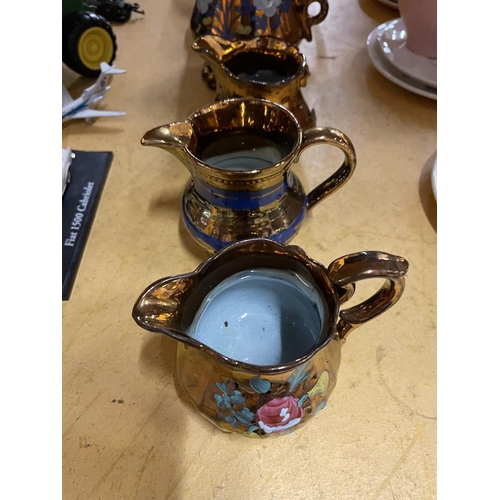 496 - A QUANTITY OF BRONZE COLOURED FLORAL PATTERNED GRADUATING JUGS PLUS A TEAPOT