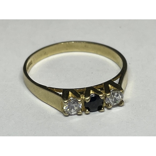 510 - A 9 CARAT GOLD RING WITH THREE IN LINE STONES TO INCLUDE A CENTRE SAPPHIRE AND TWO CUBIC ZIRCONIAS S... 