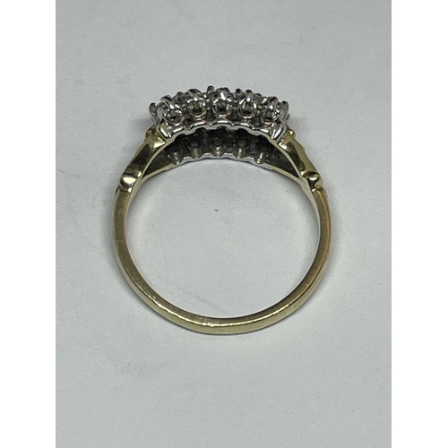 513 - A 9 CARAT GOLD RING WITH FIFTEEN CUBIC ZIRCONIA STONES IN A CLUSTER DESIGN SIZE N