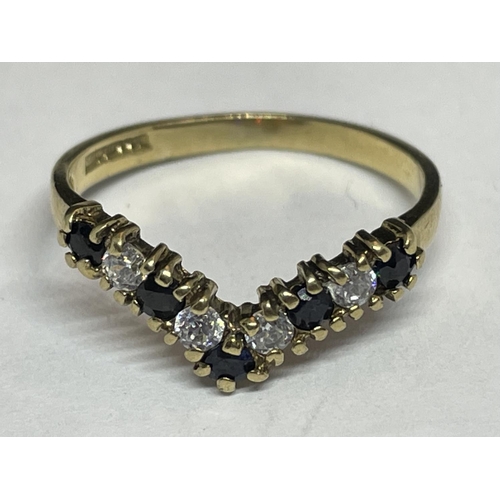 514 - A 9 CARAT GOLD WISHBONE RING WITH FIVE SAPPHIRES AND FOUR CUBIC ZIRCONIAS SIZE L