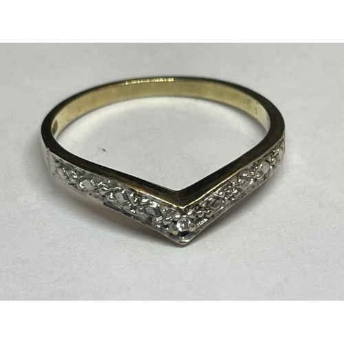 515 - A 9 CARAT GOLD RING WITH DIAMONDS IN A WISHBONE DESIGN SIZE K