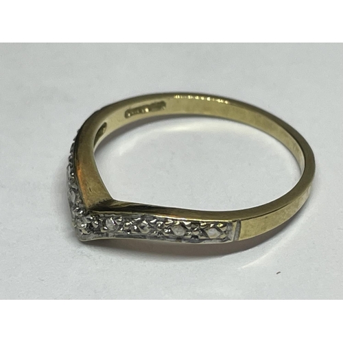 515 - A 9 CARAT GOLD RING WITH DIAMONDS IN A WISHBONE DESIGN SIZE K