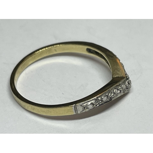 515 - A 9 CARAT GOLD RING WITH DIAMONDS IN A WISHBONE DESIGN SIZE K