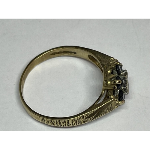 516 - A 9 CARAT GOLD RING WITH A CENTRE DIAMOND SURROUNDED BY SAPPHIRES SIZE N/M