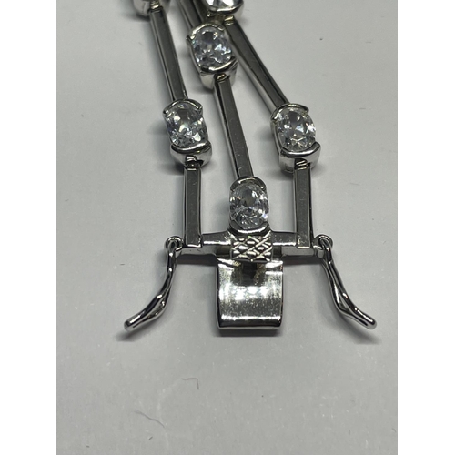 531 - A TRIPLE STRAND SILVER BRACELET WITH CLEAR STONE DECORATION IN A PRESENTATION BOX