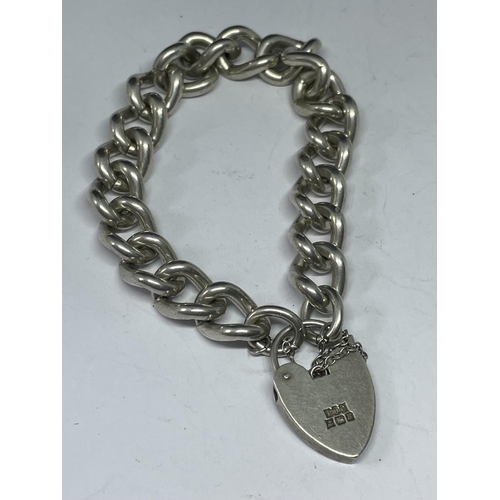 541 - A HEAVY MARKED SILVER BRACELET WITH HALLMARKED BIRMINGHAM SILVER HEART LOCJ