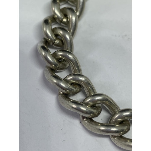 541 - A HEAVY MARKED SILVER BRACELET WITH HALLMARKED BIRMINGHAM SILVER HEART LOCJ