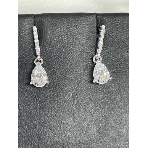 557 - A PAIR OF SILVER AND CLEAR STONE EARRINGS AND A MATCHING BRACELET IN A BOX