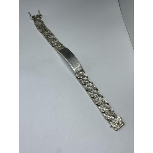 561 - A HEAVY HALLMARKED LONDON SILVER IDENTITY BRACELET