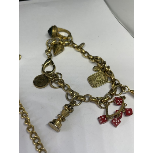 569 - TWO YELLOW METAL BRACELETS TO INCLUDE ONE WITH EIGHT CHARMS