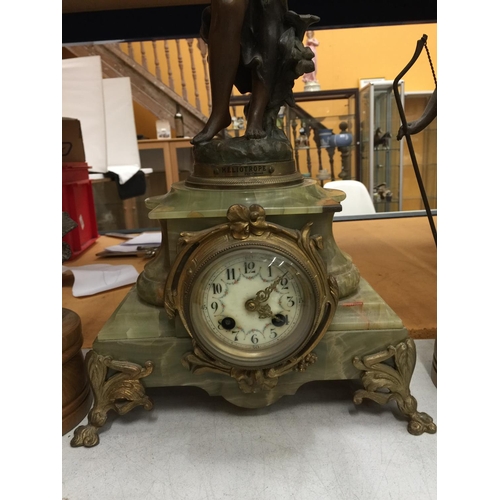 34A - A FRENCH MANTLE CLOCK ON AN ONYX BASE WITH FUGURINE GARNITURES