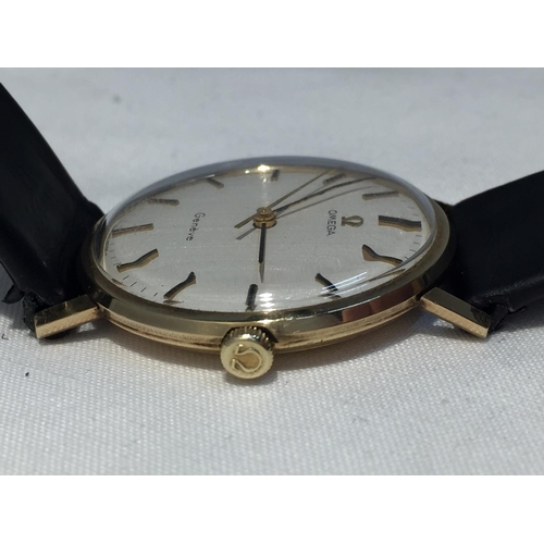 502A - AN OMEGA GENTLEMAN'S WRIST WATCH WITH 9 CARAT GOLD CASE AND LEATHER STRAP (ENGRAVED TO THE BACK PLAT... 