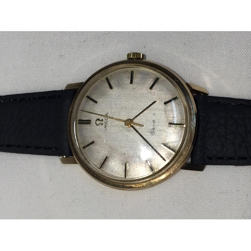 503A - AN OMEGA GENTLEMAN'S WRIST WATCH WITH 9 CARAT GOLD CASE AND LEATHER STRAP