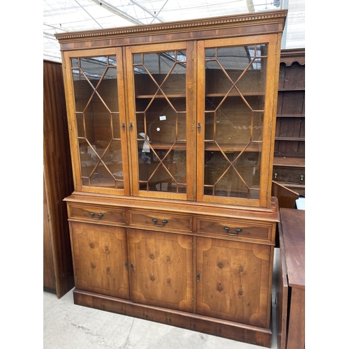 2460 - A MODERN YEW WOOD GLASED BOOKCASE ON BASE 56