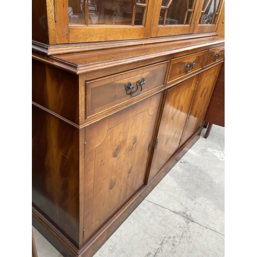 2460 - A MODERN YEW WOOD GLASED BOOKCASE ON BASE 56