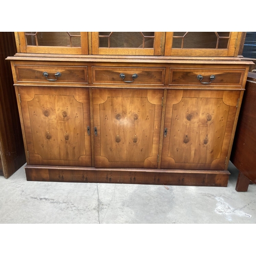 2460 - A MODERN YEW WOOD GLASED BOOKCASE ON BASE 56