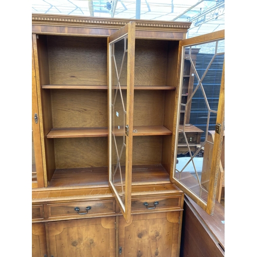 2460 - A MODERN YEW WOOD GLASED BOOKCASE ON BASE 56