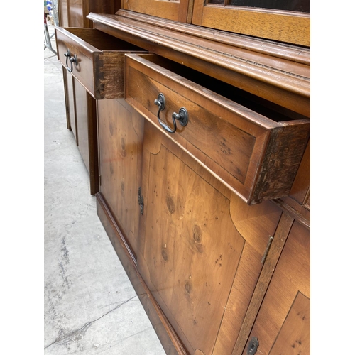 2460 - A MODERN YEW WOOD GLASED BOOKCASE ON BASE 56