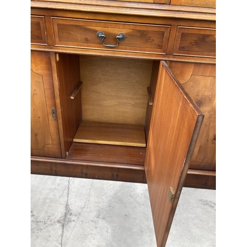 2460 - A MODERN YEW WOOD GLASED BOOKCASE ON BASE 56