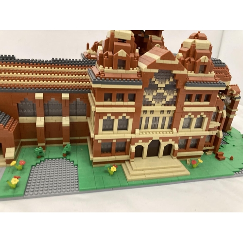 211 - A QUANTITY OF SMALL LEGO STYLE BRICKS AND BASE BUILT AS A TOWN HALL