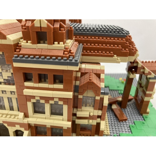 211 - A QUANTITY OF SMALL LEGO STYLE BRICKS AND BASE BUILT AS A TOWN HALL