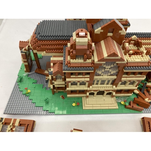 211 - A QUANTITY OF SMALL LEGO STYLE BRICKS AND BASE BUILT AS A TOWN HALL