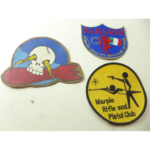 326 - A PAINTED LEATHER PATCH WITH SKULL AND BOMB DECORATION, SHOOTING PATCH