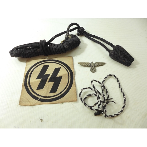 328 - A NAZI GERMANY SS CLOTH BADGE, TWO LOTS OF BRAID AND AN EAGLE & SWASTIKA BADGE