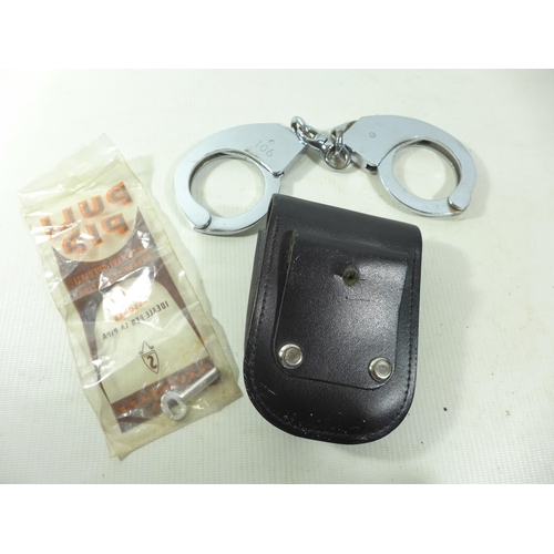 332 - A PAIR OF HANDCUFFS, KEY AND POUCH