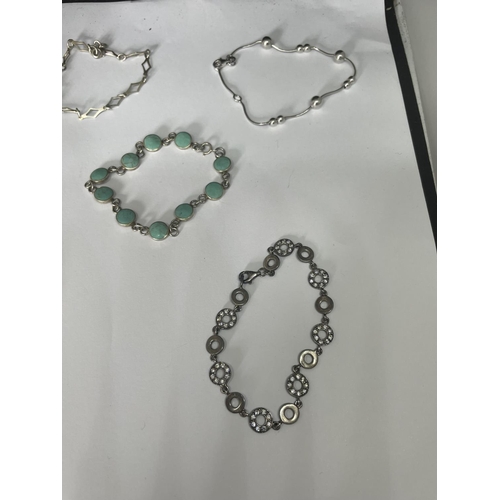 508 - FIVE SILVER BRACELETS TO INCLUDE A TURQOISE STONE AND A CLEAR STONE