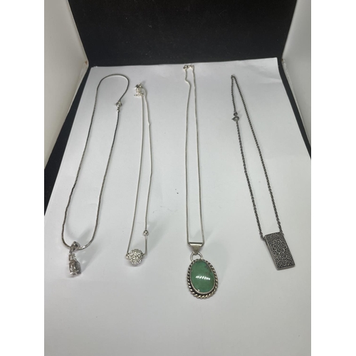 516 - FOUR MARKED SILVER NECKLACES WITH PENDANTS TO INCLUDE A CLEAR STONE BALL AND A GREEN STONE