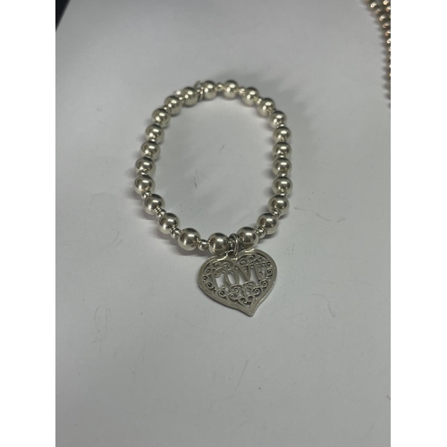 534 - A MARKED SILVER BALL DESIGN NECKLACE AND BRACELET WITH A HEART DESIGN CHARM